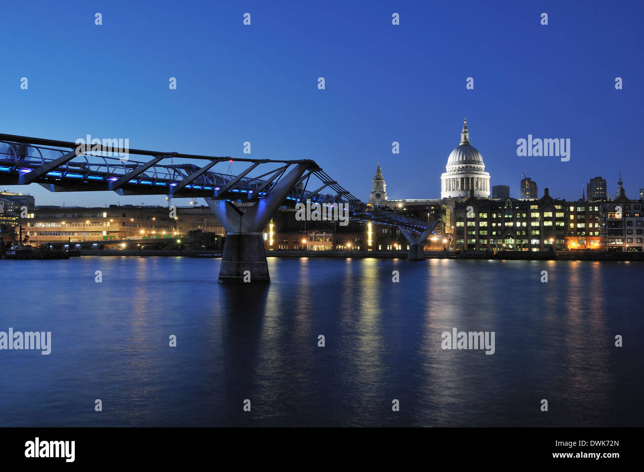 The Millennium Bridge, London UK, in the early evening, from the South Bank, with the floodlit St Paul's Cathedral dome Stock Photo