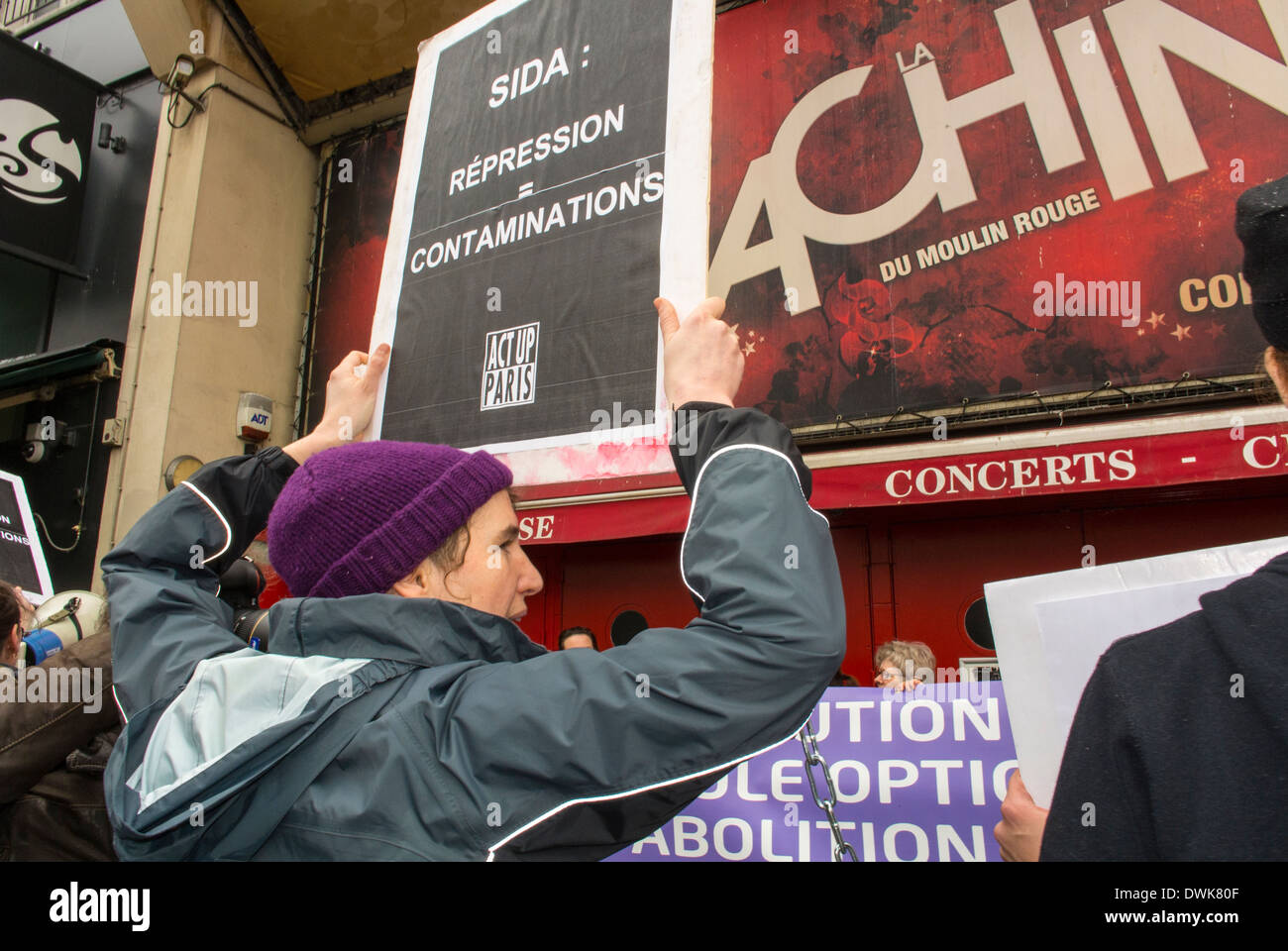 European Activists Group, ACT UP Demonstrators, Protesting at Moulin Rouge, Against Anti-Prostitution Meeting by Feminist Groups, woman protesting, Holding Protest Sign from Behind, ACT UP aids protests Stock Photo