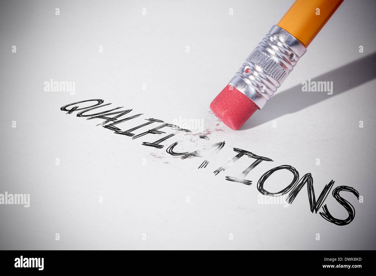 Pencil erasing the word Qualifications Stock Photo