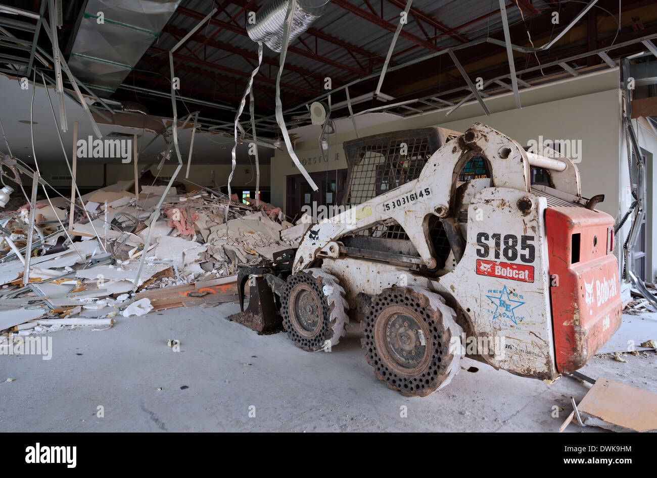 A skid loader sits inside a church undergoing demolition. Harvest Bible Chapel, Oakville, Ontario, Canada. Stock Photo