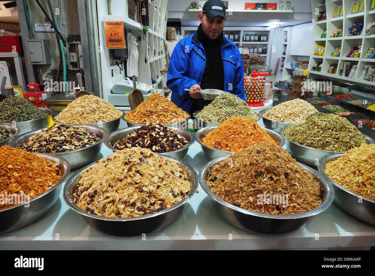 A seller standing behind his display of condiments for sale at Mehane