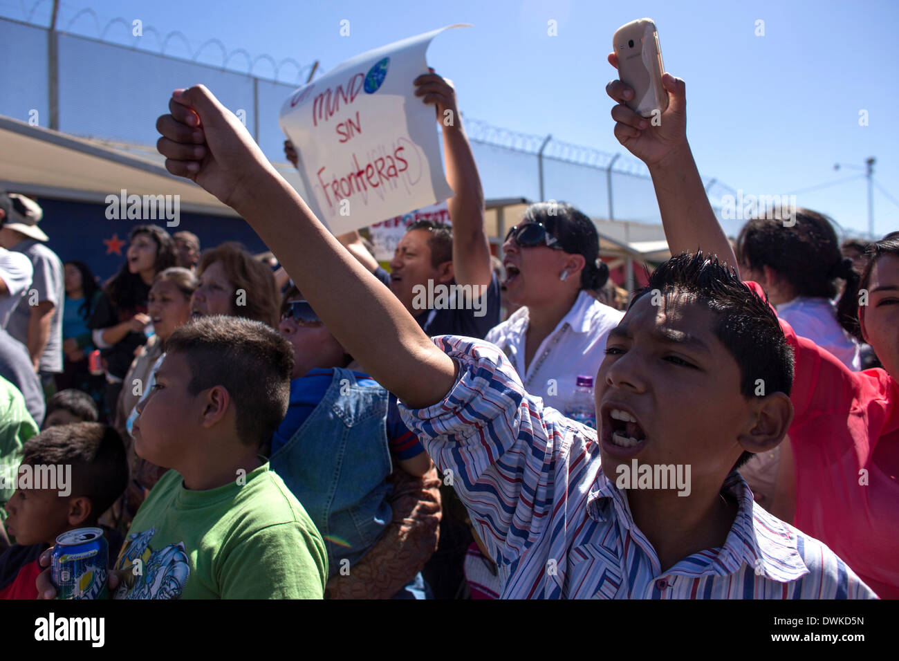 Tijuana, Mexico. 10th Mar, 2014. Demonstrators on the Mexican side support the young immigrants who are part of the group called 'dreamers' as they cross towards U.S. at the Otay Border Crossing in Tijuana, northwest Mexico, on March 10, 2014. About 30 people organized by the U.S. association Dreamactivist crossed the border into the United States seeking political asylum on Monday. Credit:  Guillermo Arias/Xinhua/Alamy Live News Stock Photo