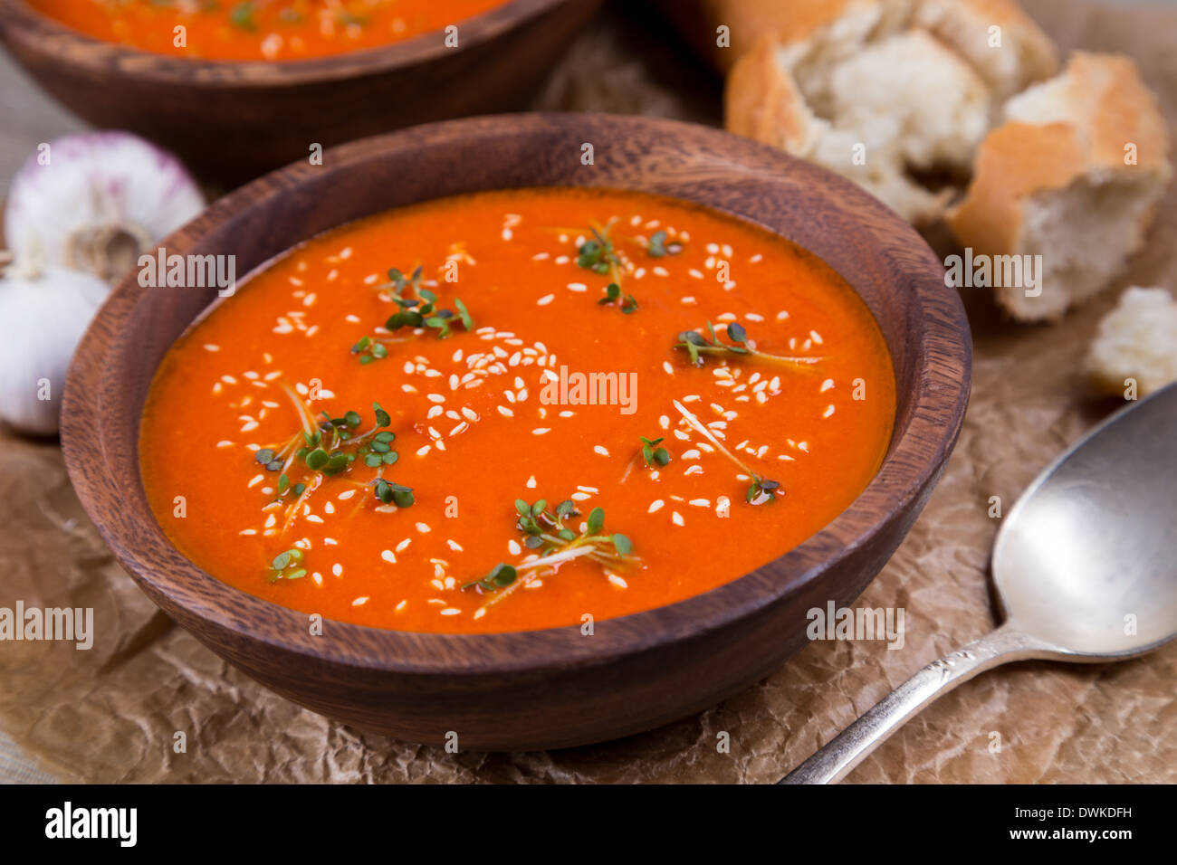 tomatos soup puree in wooden bowl on crushed brown paper Stock Photo