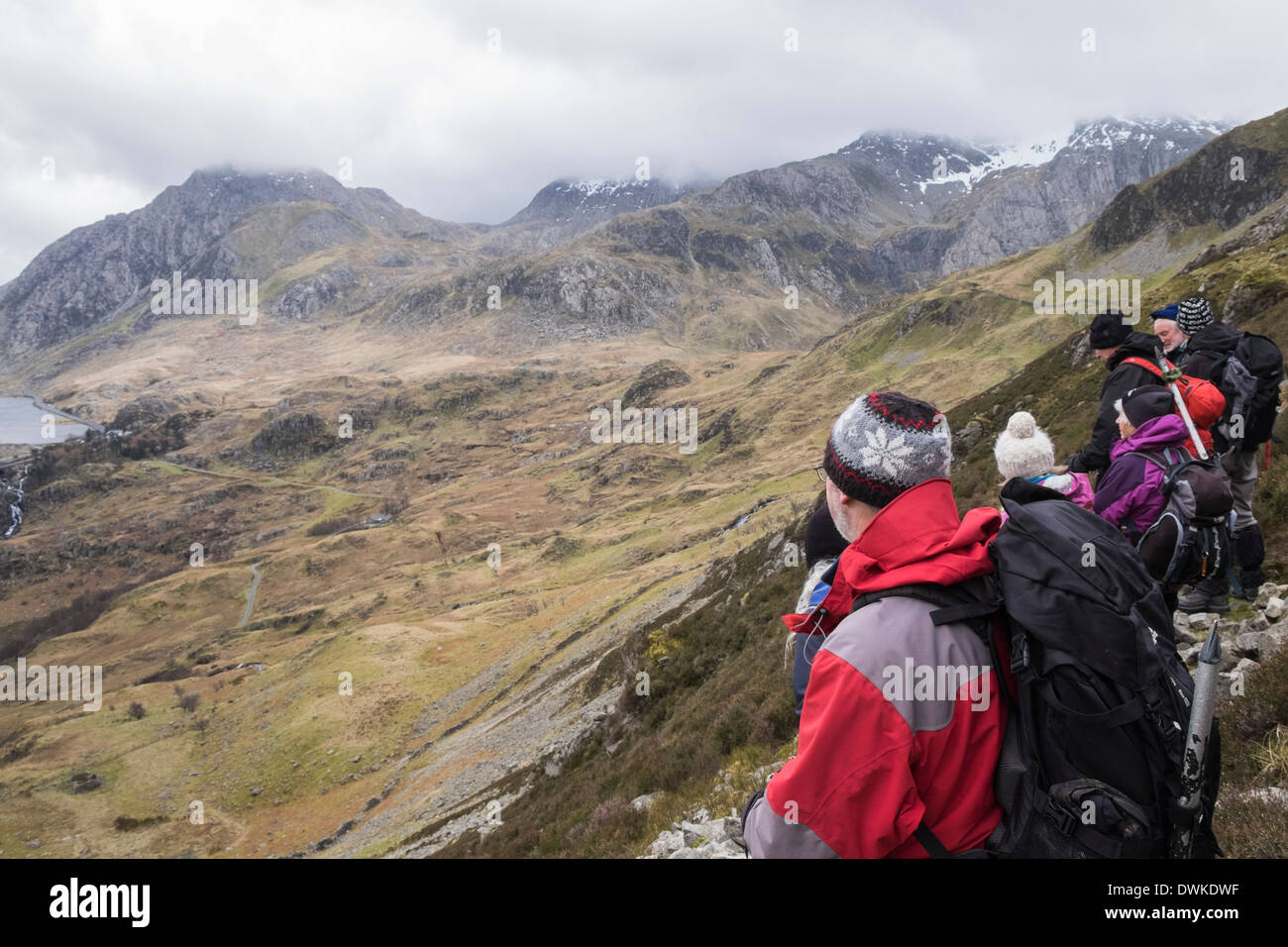 Hikers on lower slopes of Y Garn above Nant Ffrancon looking at view to Ogwen Valley in Snowdonia National Park Wales UK Britain Stock Photo