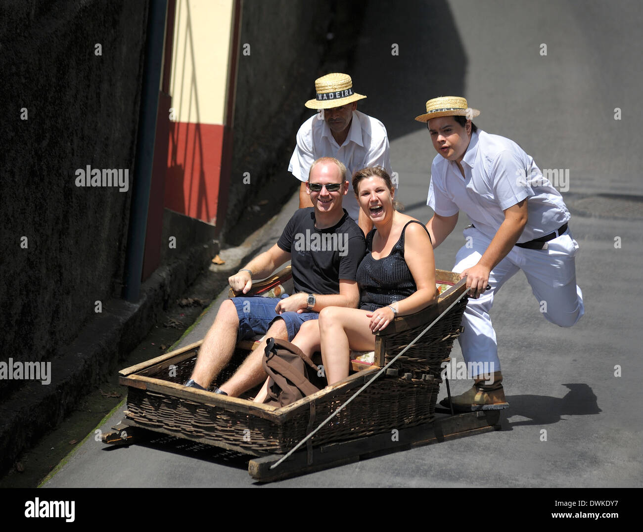 Monte Madeira Portugal,a happy young couple enjoying the toboggan ride down the hill to Funchal Stock Photo
