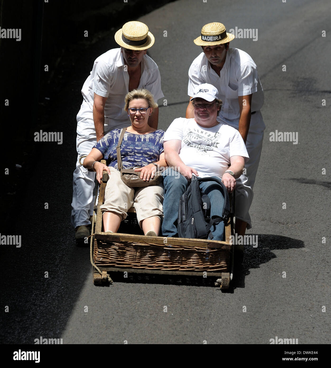 Monte Madeira Portugal,a happy couple enjoying the toboggan ride down the hill to Funchal Stock Photo