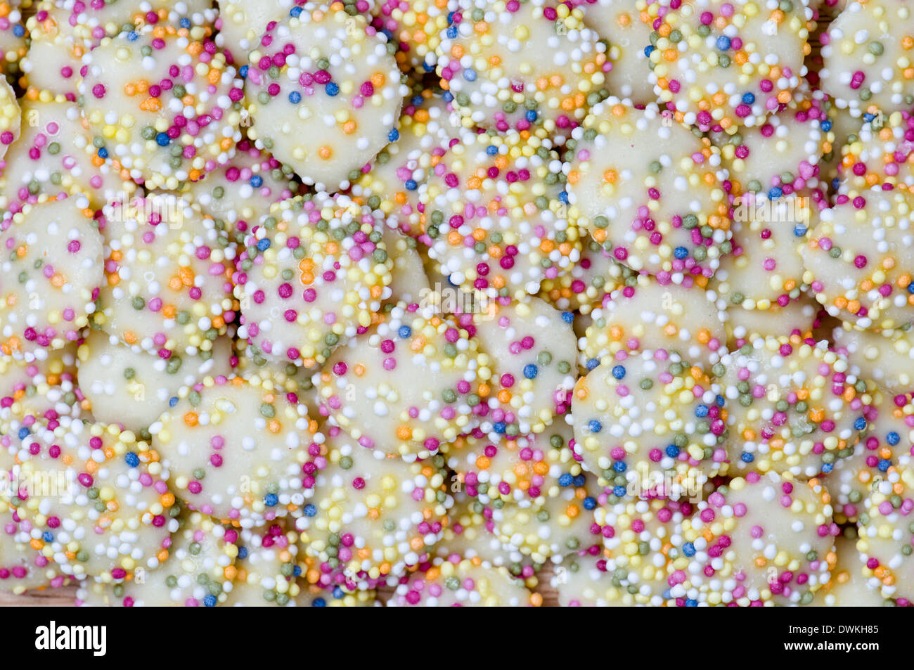 White chocolate buttons with coloured sprinkles or hundreds and thousands Stock Photo