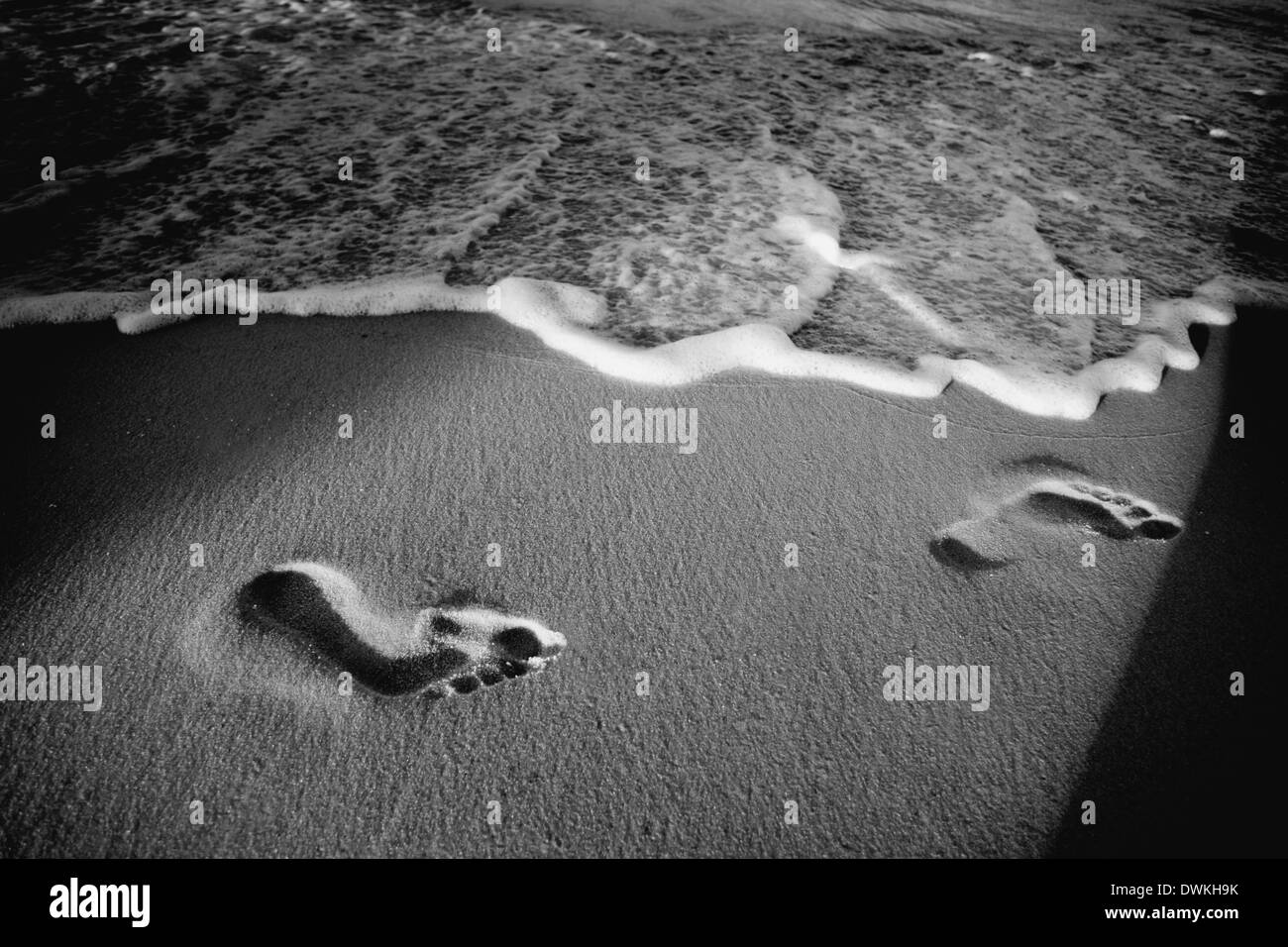 Footprints sand sunset Black and White Stock Photos & Images - Alamy