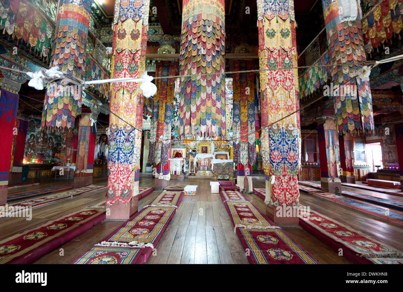 Prayer hall in Tawang Buddhist monastery with pillars covered in prayer flags, Tawang, Arunachal Pradesh, India Stock Photo