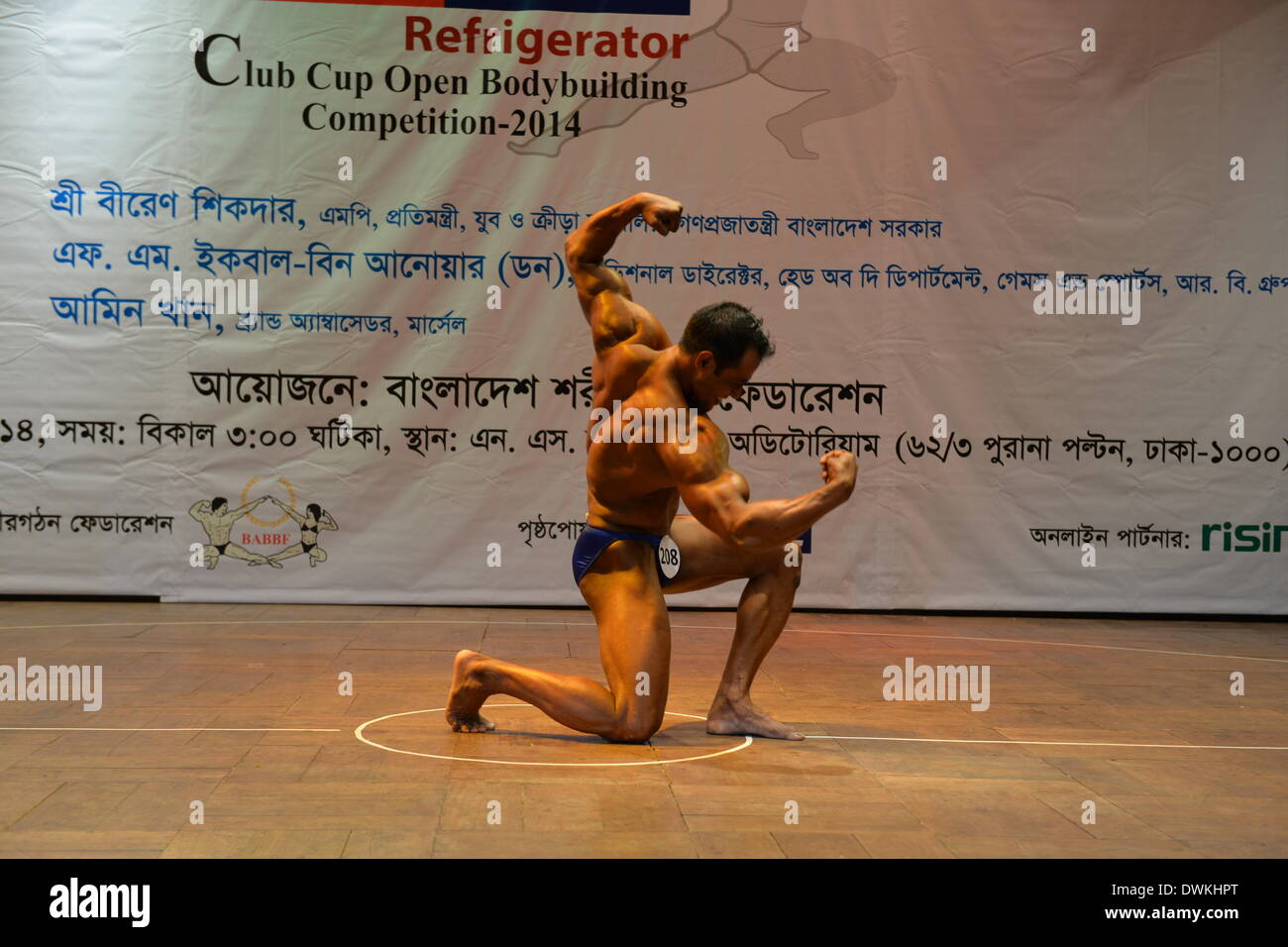 Dhaka, Bangladesh. 10th Mar, 2014. A Bangladeshi bodybuilder competes in a Club Cup Open Bodybuilding competition in Dhaka, Bangladesh, March 10, 2014. Some 250 bodybuilders from 55 clubs are expected to participate in the meet in seven-weight-categories. Credit:  Shariful Islam/Xinhua/Alamy Live News Stock Photo