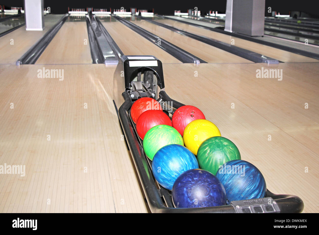Empty light bowling club, lot of multicolored balls Stock Photo