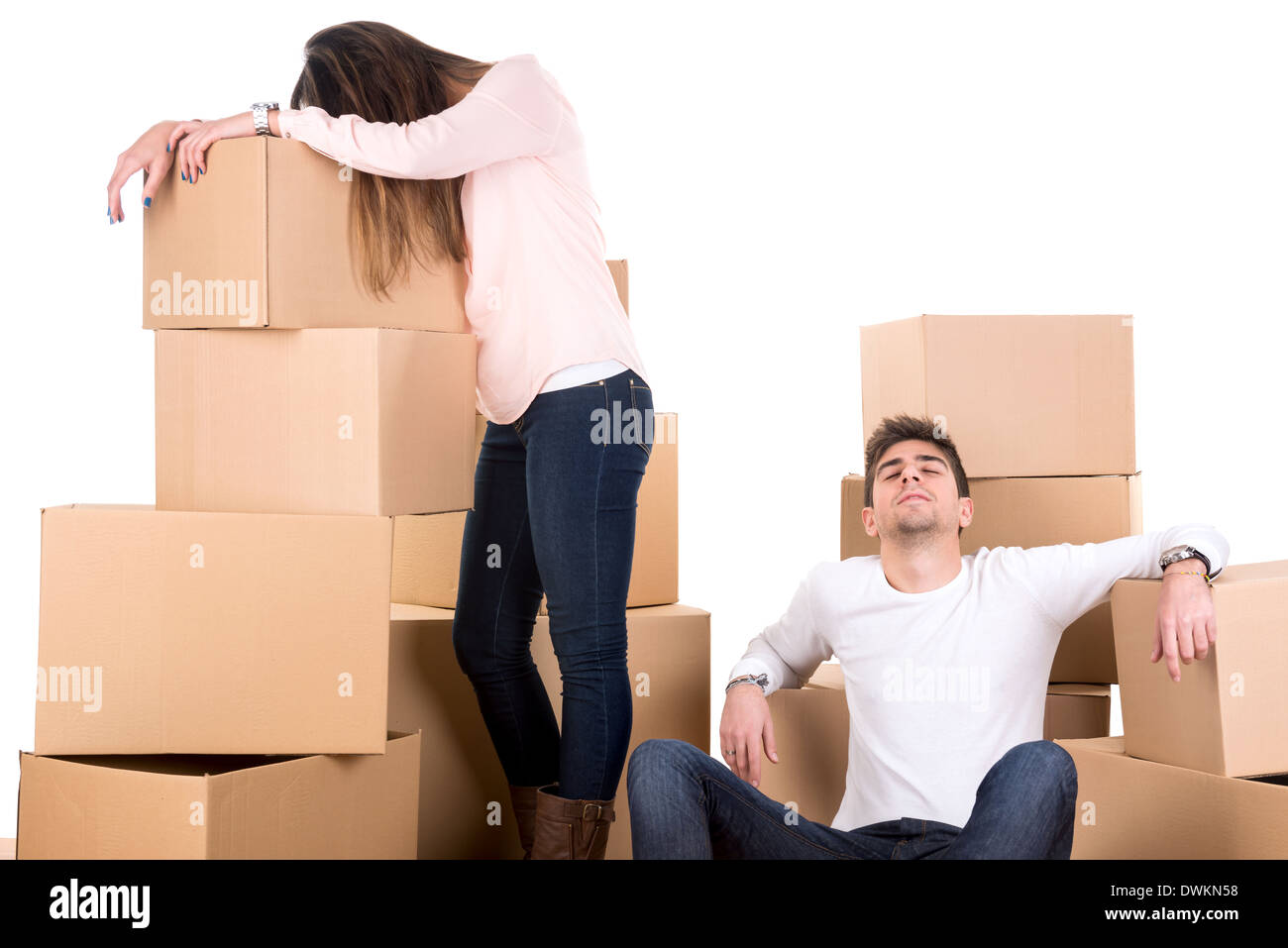 Tired couple with boxes moving into new home apartment Stock Photo