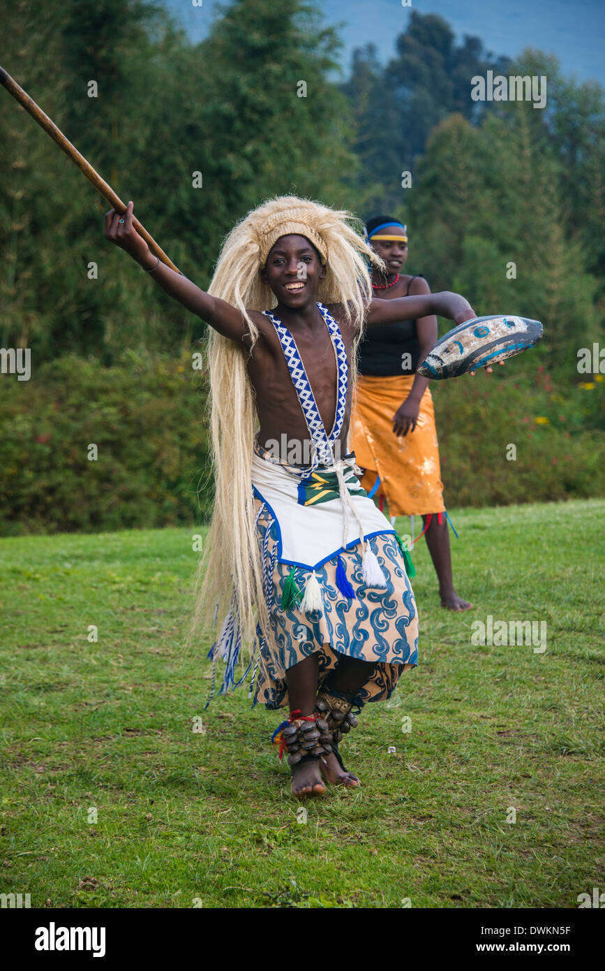 Man carrying a wig and a spear at a ceremony of former poachers, in the  Virunga National Park, Rwanda, Africa Stock Photo - Alamy