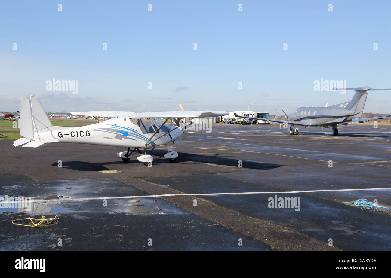 cockpit of a Icarus C42 microlight plane with a pilatus PC12 in the background at blackbushe airport Stock Photo