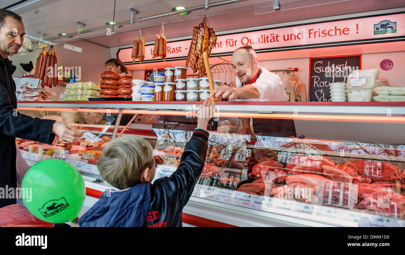 Berlin, Germany. 28th Feb, 2014. The mobile butcher of butcher Ingo Rast on  February 28, 2014 in Berlin, Germany. A child gets a sausage in his hand.  Photo: picture alliance/Robert Schlesinger/dpa/Alamy Live