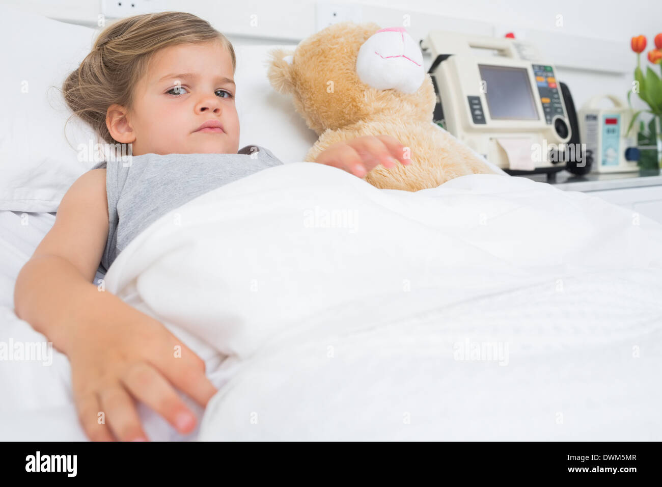Cute girl lying in hospital bed Stock Photo