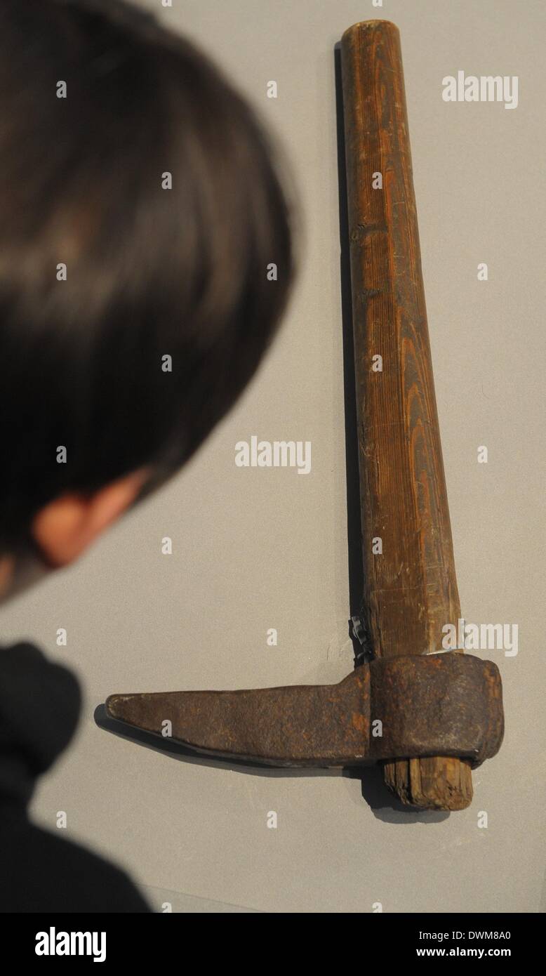 Leipzig, Germany. 11th Mar, 2014. A visitor looks at a pickaxe which was used by Soviet prisoners at the exhibition 'Gulag. Traces and evidences' at the Forum of Contemporary History Leipzig in Leipzig, Germany, 11 March 2014. The exhibition focuses on the history of the system of criminal and forced labor camps in the former Soviet Union and runs from 12 March until 29 June 2014. Photo: PETER ENDIG/dpa/Alamy Live News Stock Photo