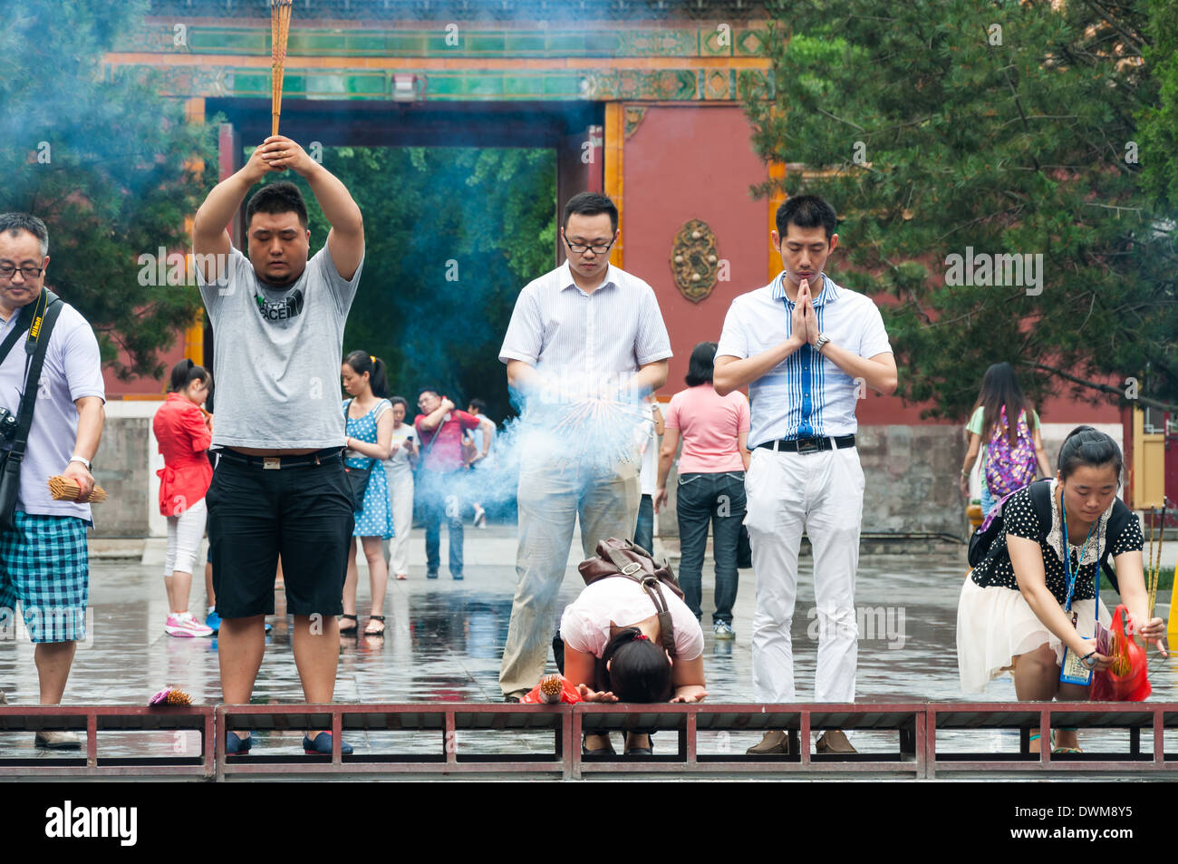 Buddhists burn incense and pray at Yonghegong Lama Temple in Beijing