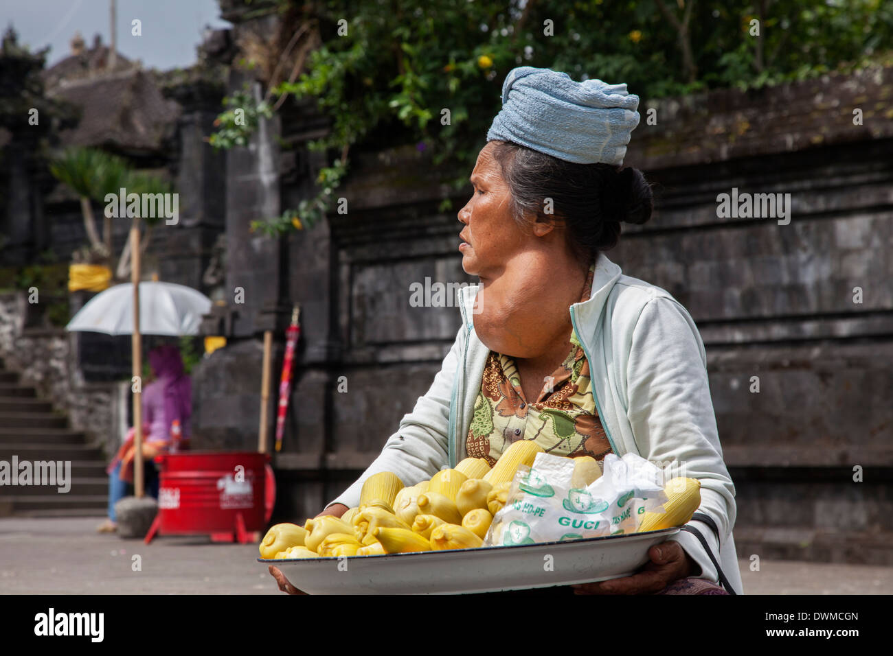 Woman with a large goitre sells fruit at Pura Besakih Temple in Bali Stock Photo