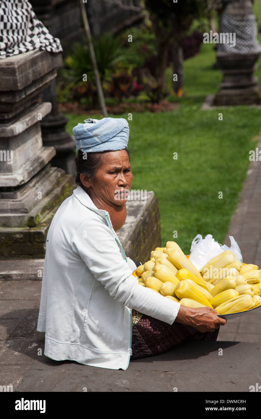 Woman with a large goitre sells fruit at Pura Besakih Temple in Bali Stock Photo
