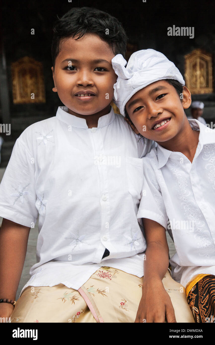Portrait of two Hindu boys dressed in white at Pura Besakih Temple in Bali Stock Photo