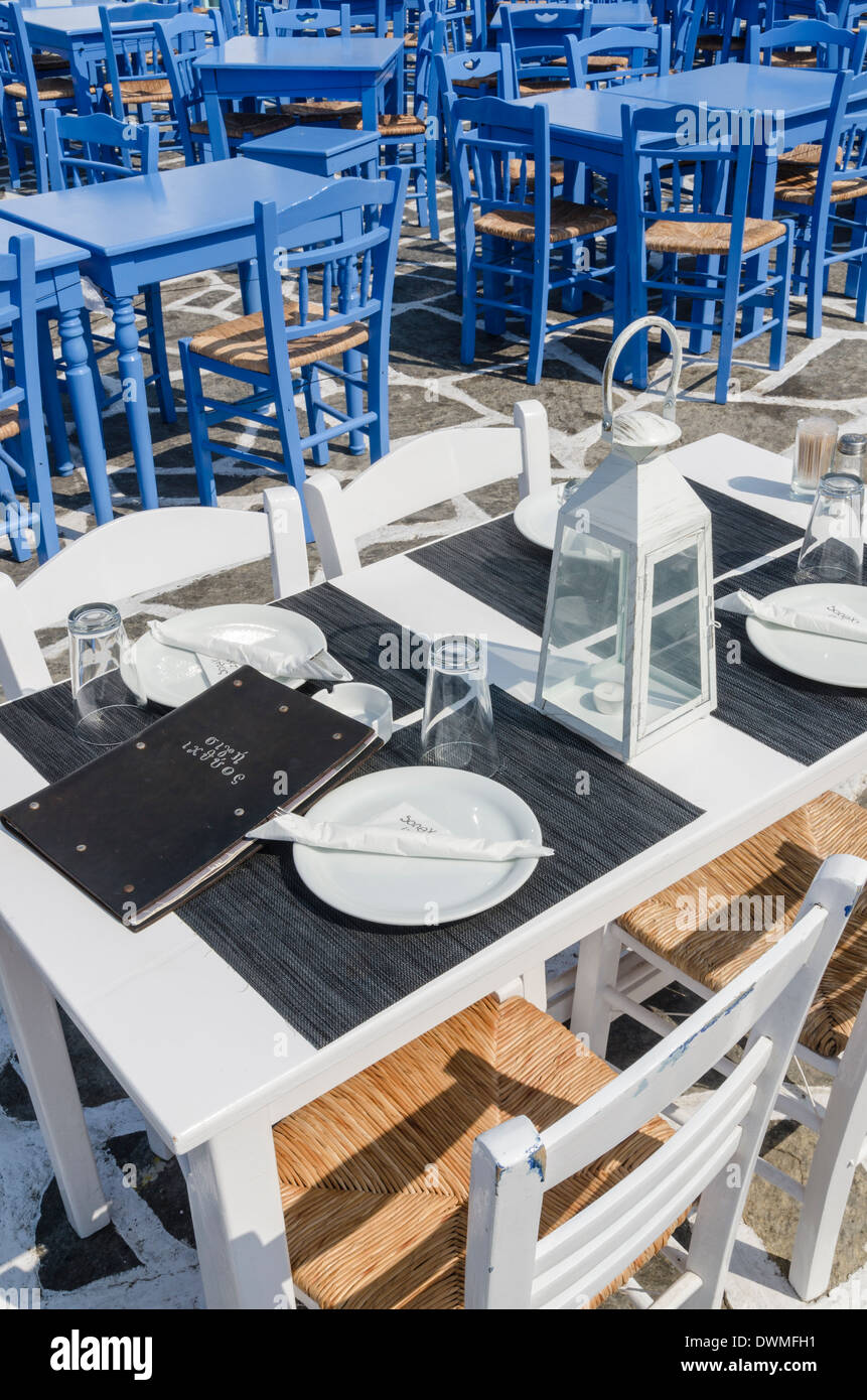 White and blue tables and chairs at Greek taverna's in the town of Naoussa, Paros, Greece Stock Photo