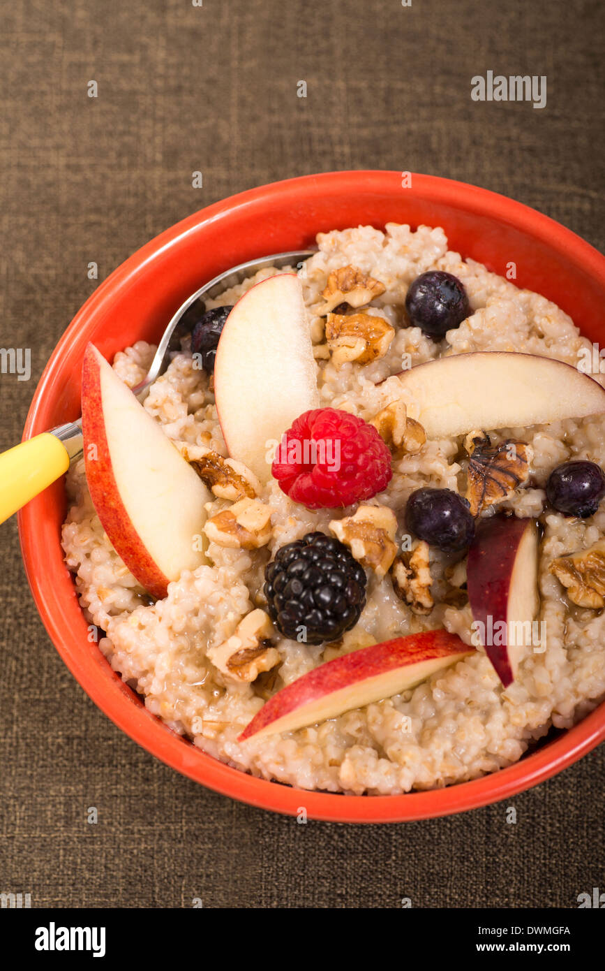 Bowl of delicious steel cut oats with fresh fruit, honey Stock Photo