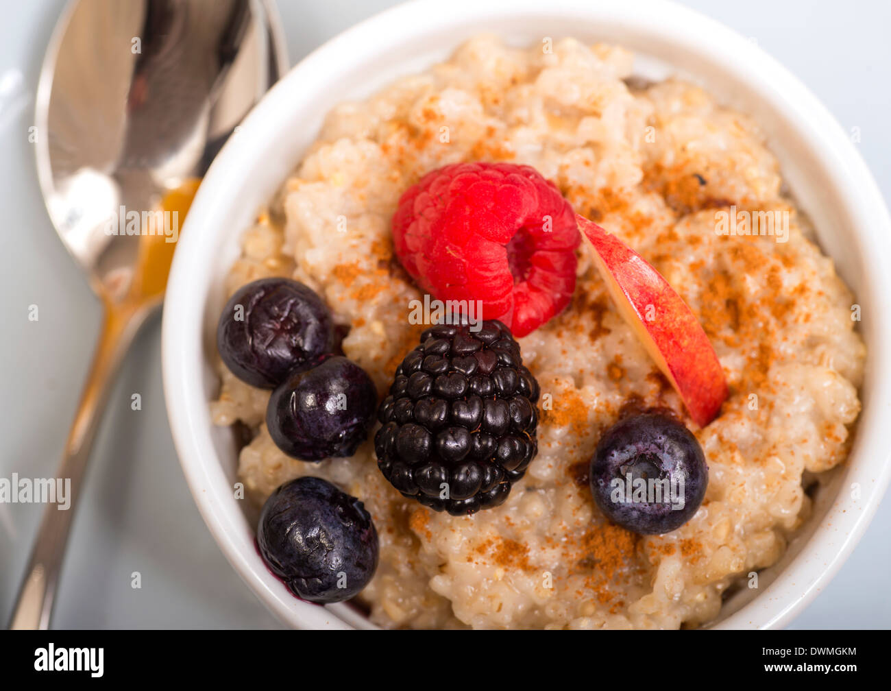 Bowl of delicious steel cut oats with fresh fruit, honey Stock Photo