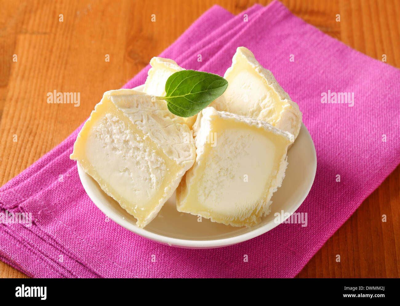 Halved Crottins de Chevre French goat's milk cheese Stock Photo Alamy
