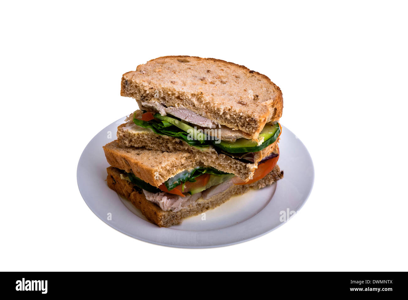 Granary bread chicken sandwich, on a white plate. Stock Photo