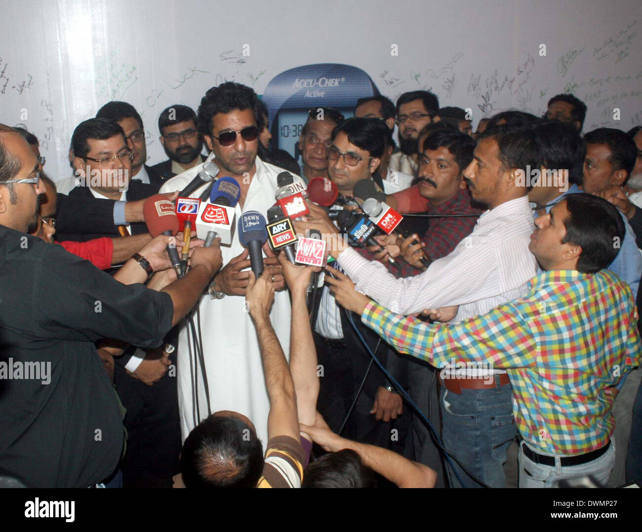 Former cricketer Wasim Akram talks to media persons during launching