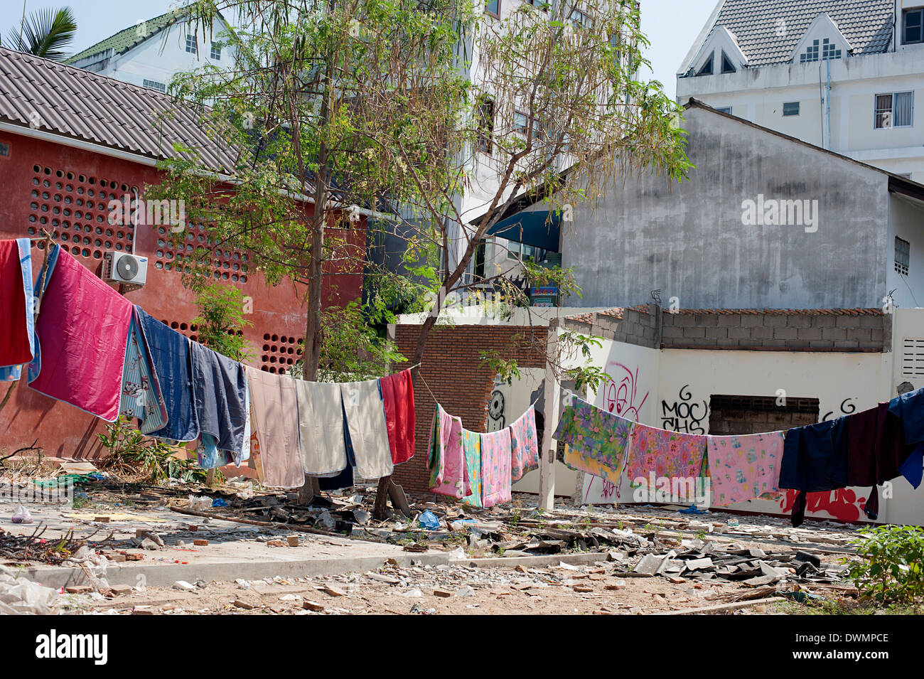 Washing hanging out to dry over derelict piece of land in Chiang Mai, Northern Thailand Stock Photo