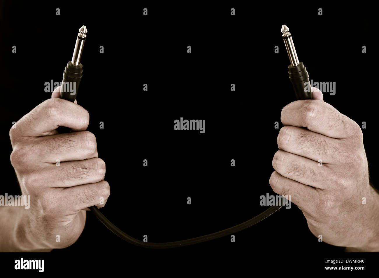 Hands with audio cable  color processed Stock Photo