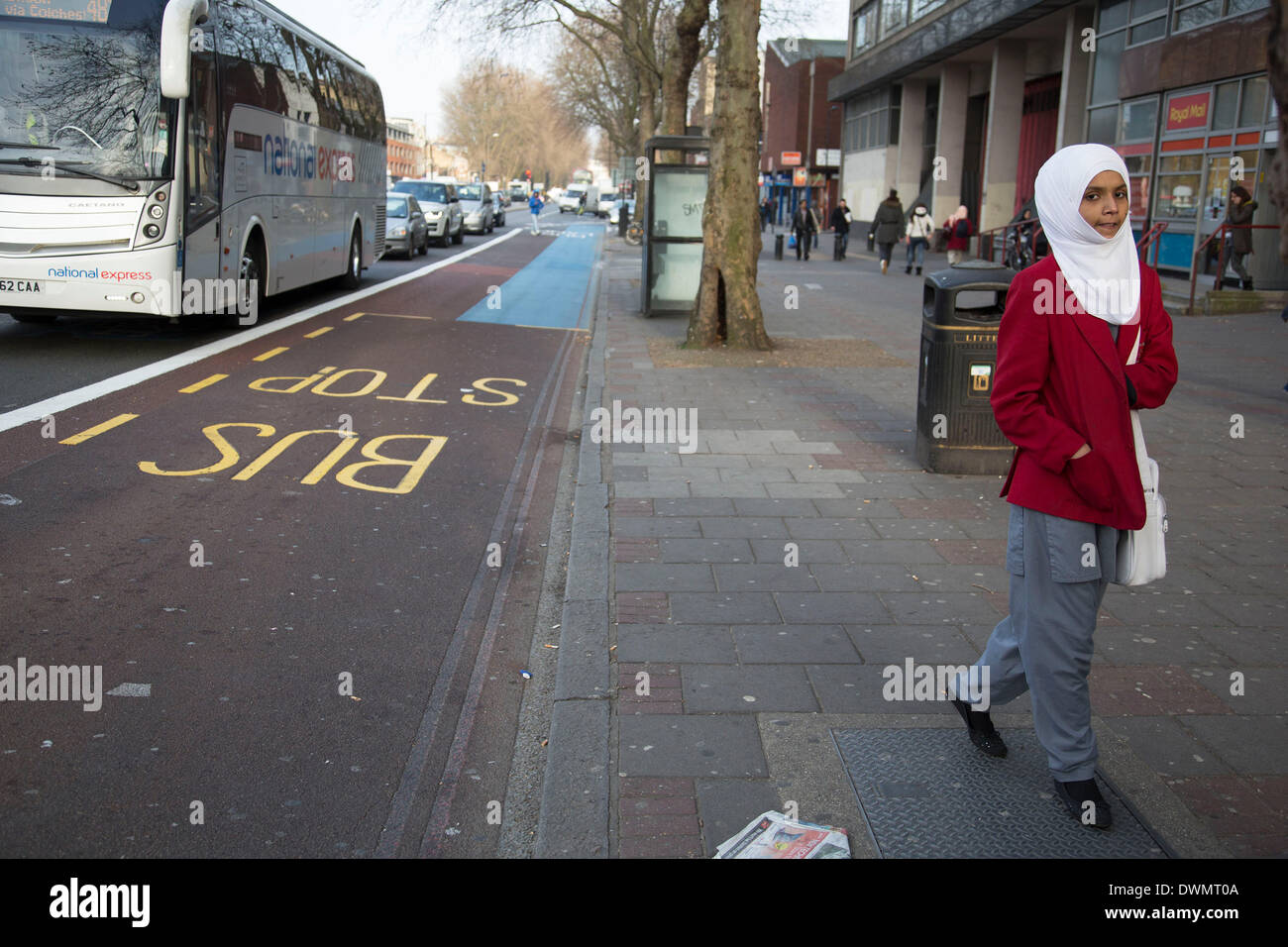 Whitechapel, London, UK. 11th Mar, 2014. People from various ethnic backgrounds around the market on Whitechapel High Street in East London. This area in the Tower Hamlets is predominantly Muslim with just over 50% of Bangladeshi descent. This is known as a very Asian and multi cultural part of London's East End. School girl in Hijab uniform. Credit:  Michael Kemp/Alamy Live News Stock Photo