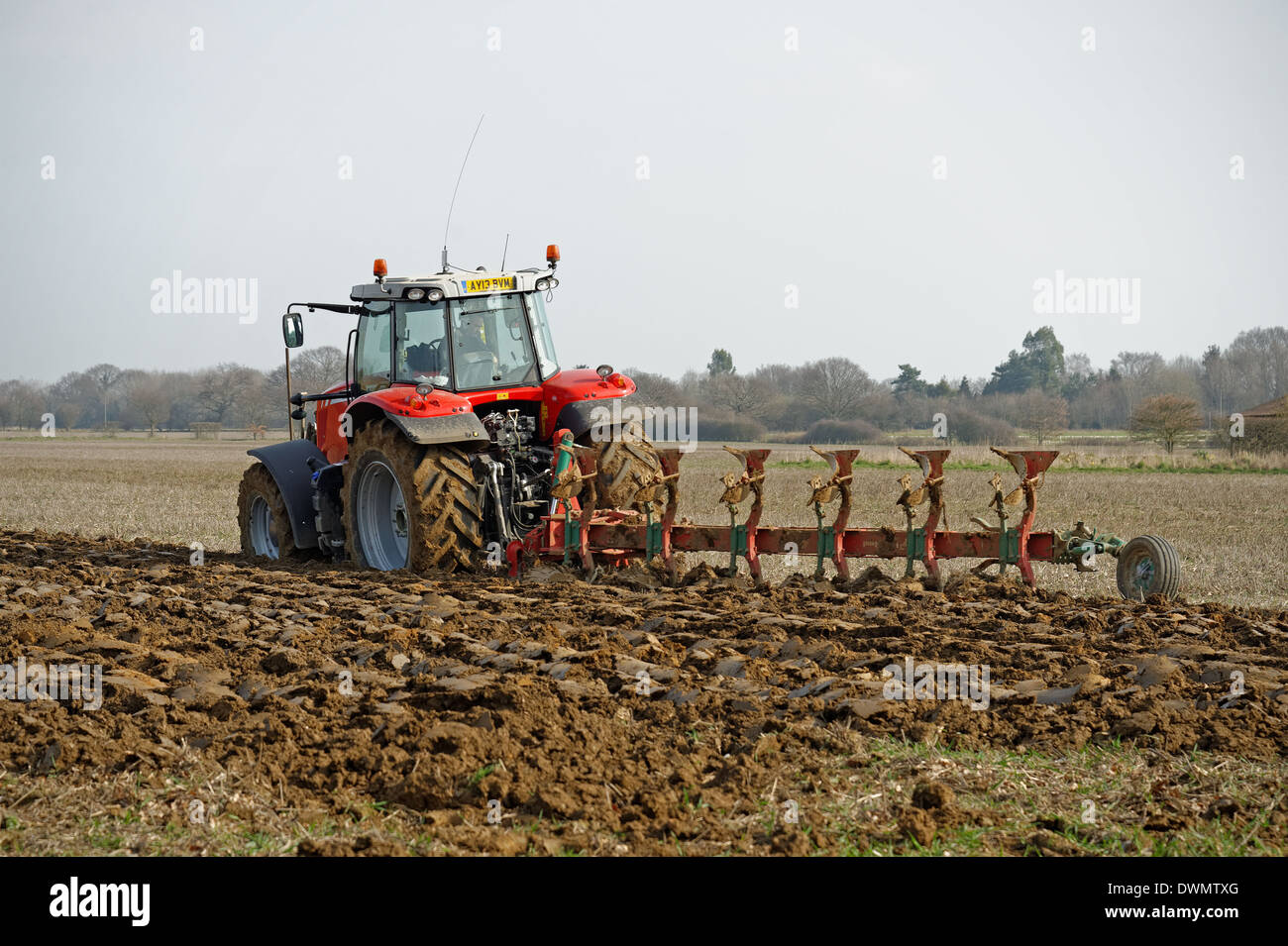 A modern tractor ploughing a field in the UK ready for sowing a crop