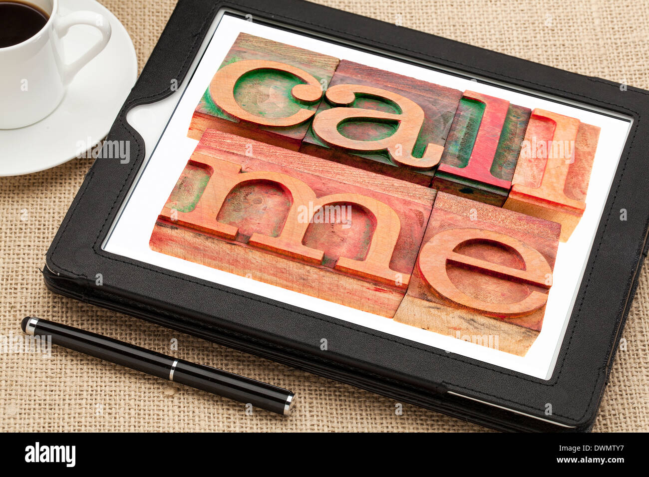 call me request or reminder - words in vintage wooden letterpress printing blocks on a digital tablet with a cup of coffee Stock Photo
