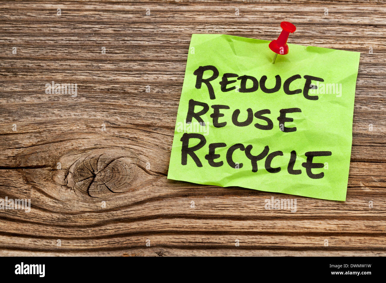 reduce, reuse and recycle reminder note against grained wood - resource conservation concept Stock Photo