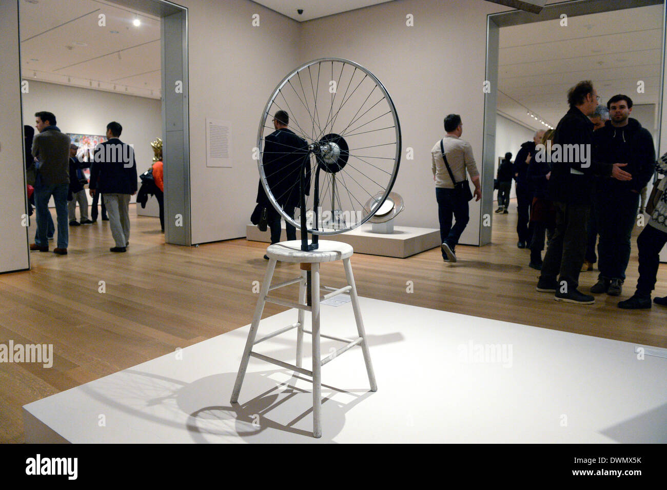 New York City, USA. 08th Mar, 2014. Visitors look at the work 'Bicycle Wheel' by artist Marcel Duchamp at the Museum of Modern Art (MoMA) in New York City, USA, 08 March 2014. Photo: Felix Hoerhager/dpa/Alamy Live News Stock Photo