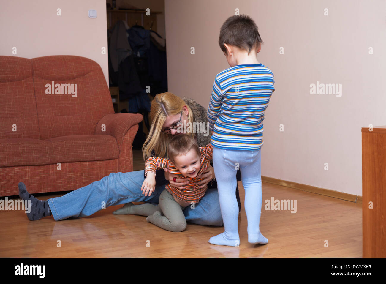 Happy children and woman having fun at home Stock Photo