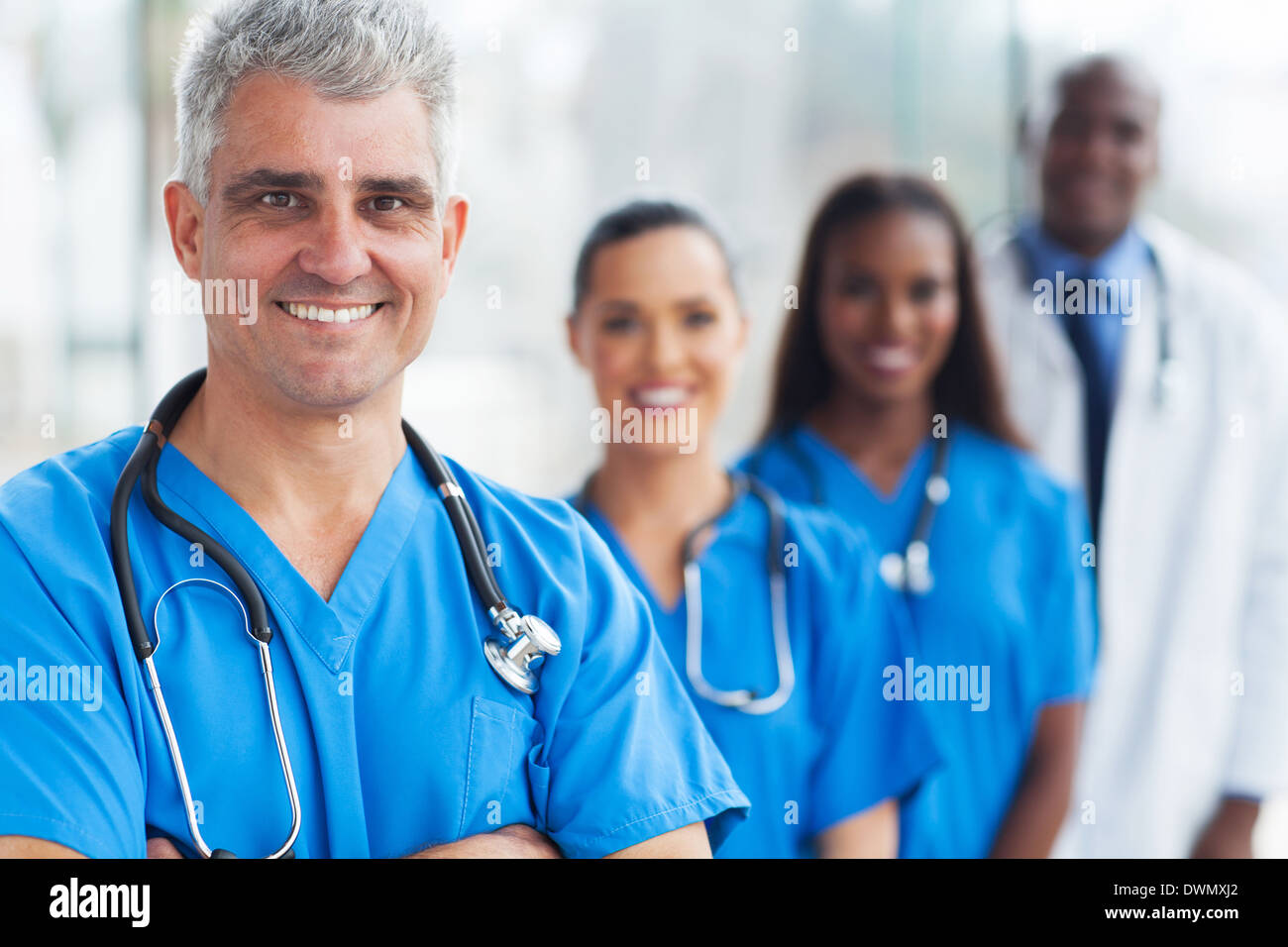 handsome senior medical doctor and team at hospital Stock Photo