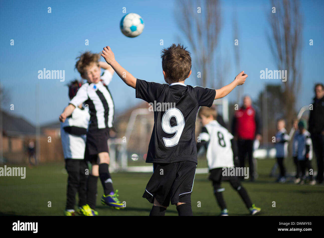 Action during a boys soccer match. Trademarks have been removed. Stock Photo