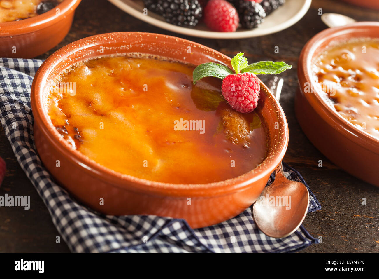 Gourmet Carmelized Creme Brulee with Berries and Mint Stock Photo