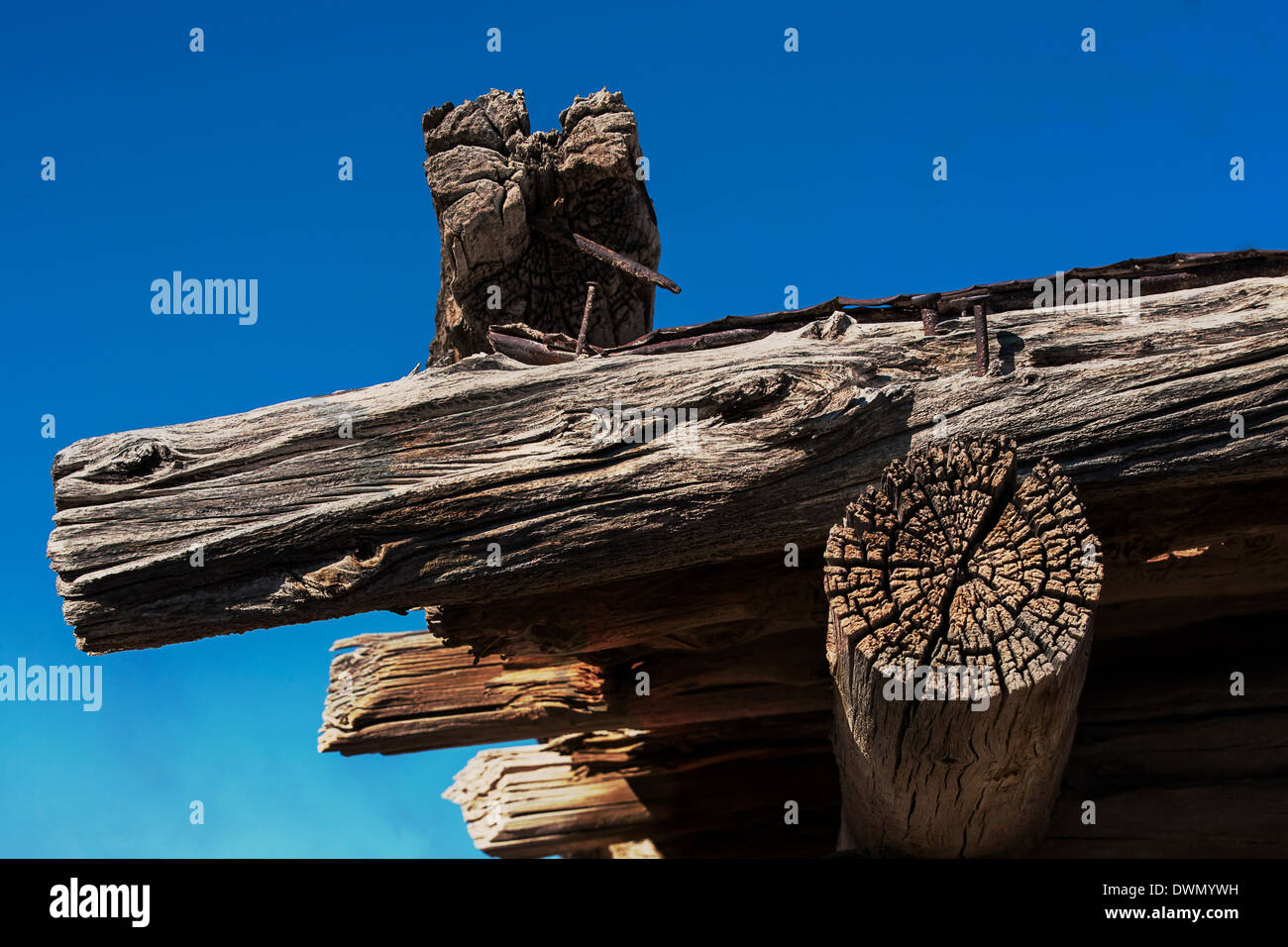 A corner of the roof of a log home in the desert that has seen better days Stock Photo