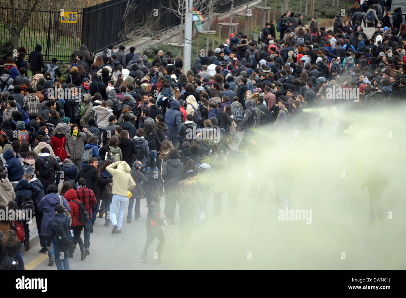 Ankara, Turkey. 11th Mar, 2014. Turkish students run away from tear gas during a protest in Ankara, capital of Turkey, March 11, 2014. Mass protests rallied on Tuesday in several cities in Turkey following the death of 15-year-old Berkin Elvan, who had been in coma for 269 days due to a head injury by a tear gas canister during the Gezi Park protests in last June. Credit:  Mustafa Kaya/Xinhua/Alamy Live News Stock Photo