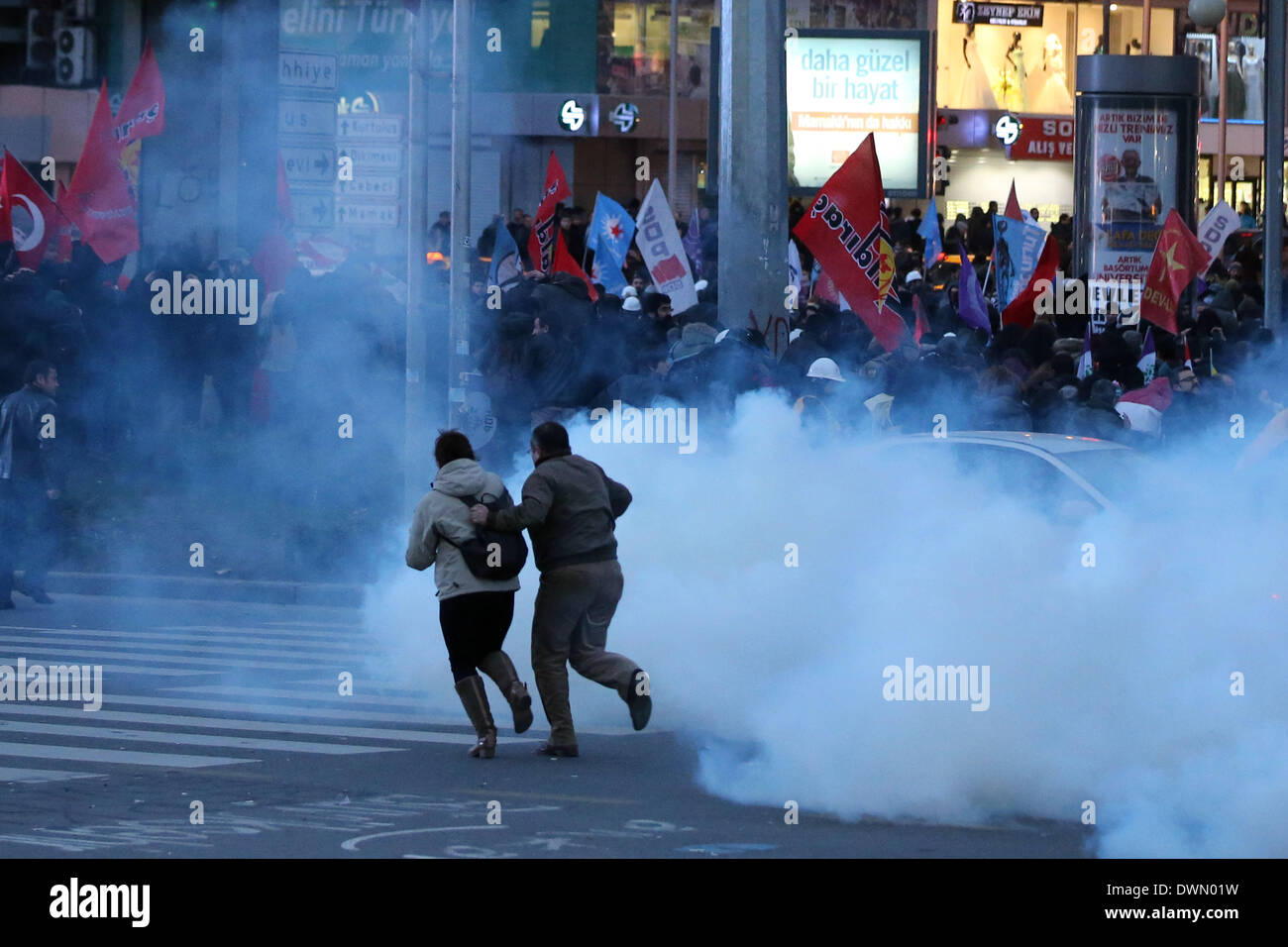 Ankara, Turkey. 11th Mar, 2014. Turkish people run away from tear gas during a protest in Ankara, capital of Turkey, March 11, 2014. Mass protests rallied on Tuesday in several cities in Turkey following the death of 15-year-old Berkin Elvan, who had been in coma for 269 days due to a head injury by a tear gas canister during the Gezi Park protests in last June. Credit:  Mustafa Kaya/Xinhua/Alamy Live News Stock Photo