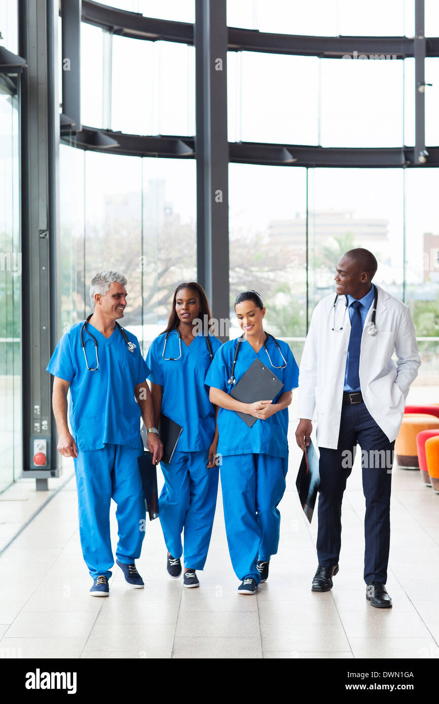 group of professional health care workers walking in hospital Stock Photo