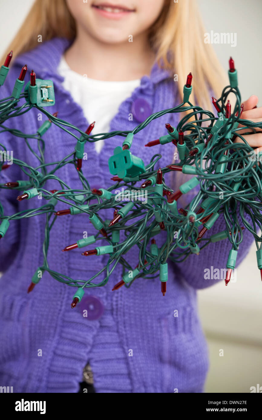 Girl Holding Tangled Fairy Lights Stock Photo Alamy
