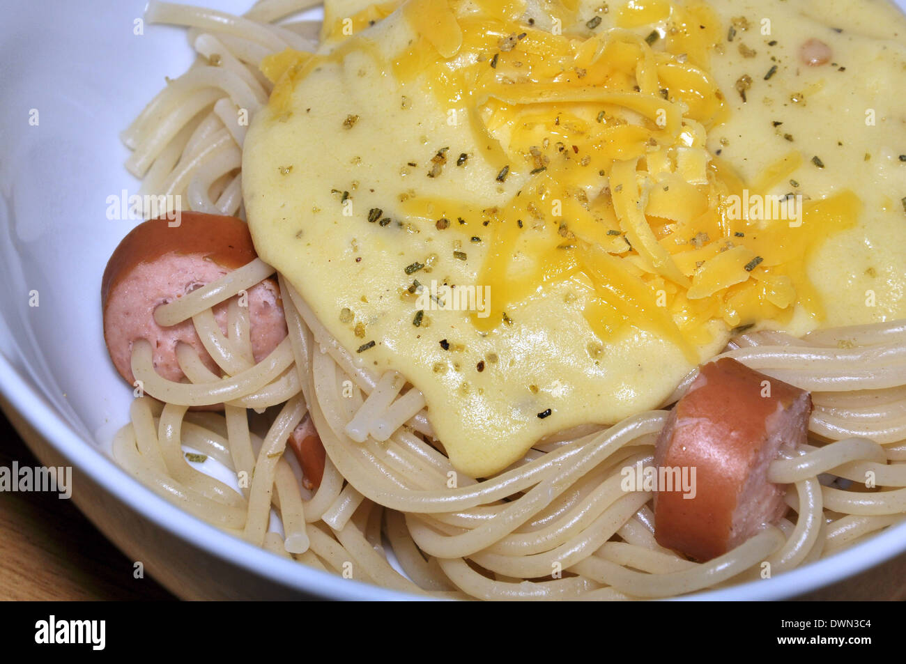Spaghetti knack wurst and cheese with herb sauce Stock Photo