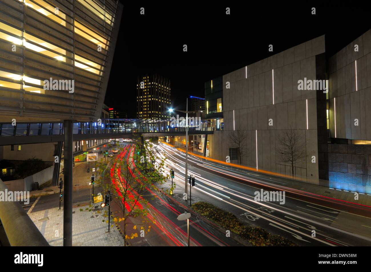 Light trails made by traffic passing through the built up area of the Cabot circus development in the city of Bristol at night. Stock Photo