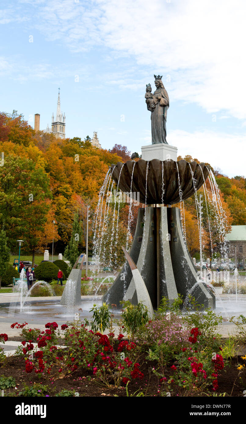 Statue of Sainte Anne de Beaupre with infant Jesus in front of Basilica and fountain Stock Photo